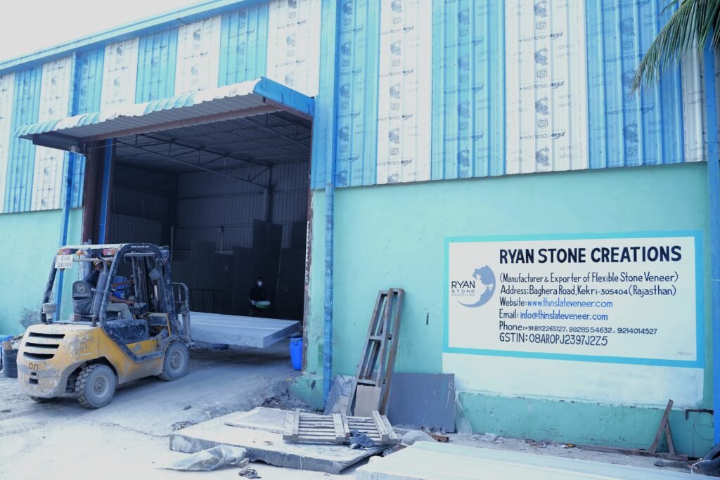 Manual peeling of natural flexible slate veneer sheet from raw stone block in factory